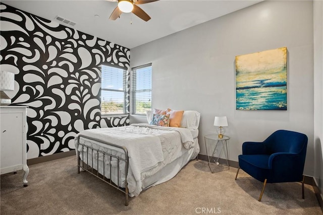 bedroom with carpet floors, baseboards, visible vents, and a ceiling fan