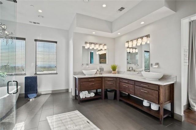 full bathroom featuring visible vents, a sink, and double vanity