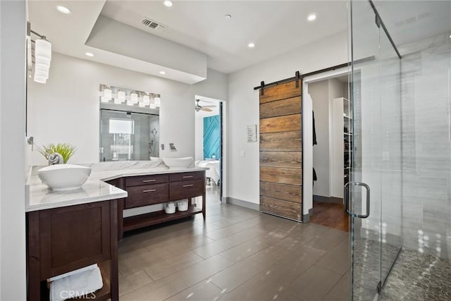 full bath with recessed lighting, a shower stall, wood finished floors, and vanity