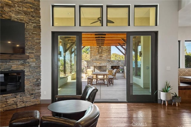 doorway with wood-type flooring and a fireplace