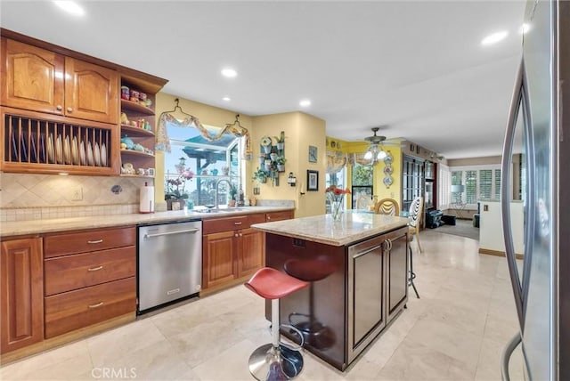 6153 Peridot Ave, Alta Loma, CA 91701 - kitchen featuring appliances with stainless steel finishes, a sink, backsplash, open shelves, and a ceiling fan