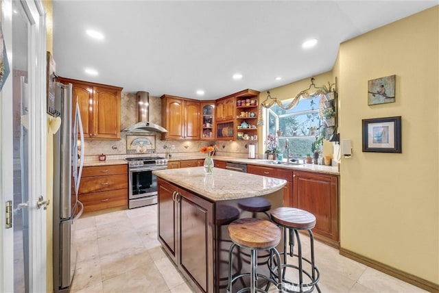 6153 Peridot Ave, Alta Loma, CA 91701 - kitchen with wall chimney range hood, appliances with stainless steel finishes, a sink, decorative backsplash, and brown cabinets