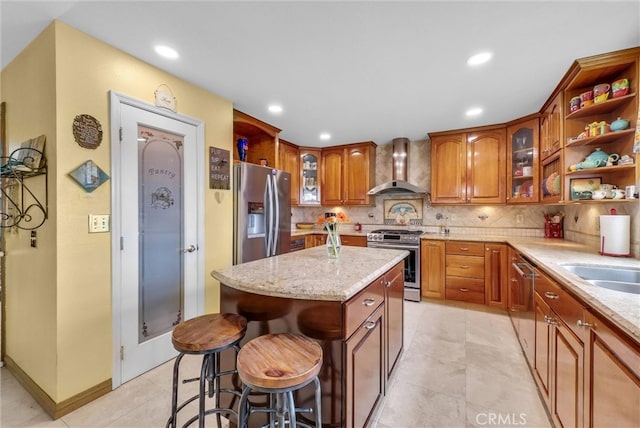 6153 Peridot Ave, Alta Loma, CA 91701 - kitchen with wall chimney exhaust hood, appliances with stainless steel finishes, brown cabinetry, decorative backsplash, and a kitchen island