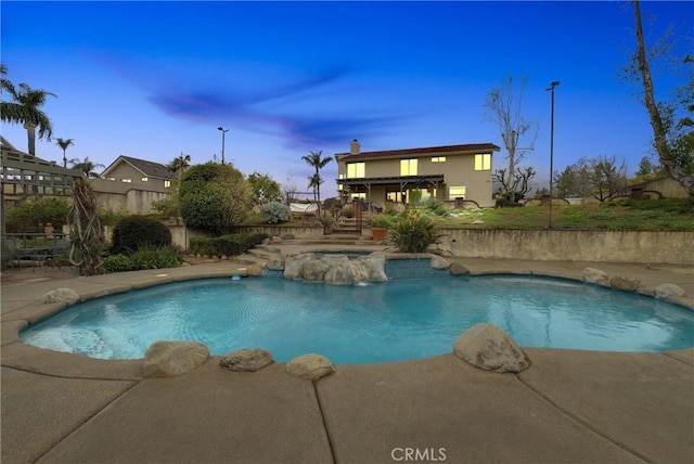 6153 Peridot Ave, Alta Loma, CA 91701 - pool at dusk featuring stairway, fence, a patio, and a pool with connected hot tub