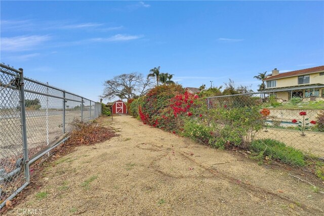 6153 Peridot Ave, Alta Loma, CA 91701 - view of yard featuring fence, a shed, and an outdoor structure