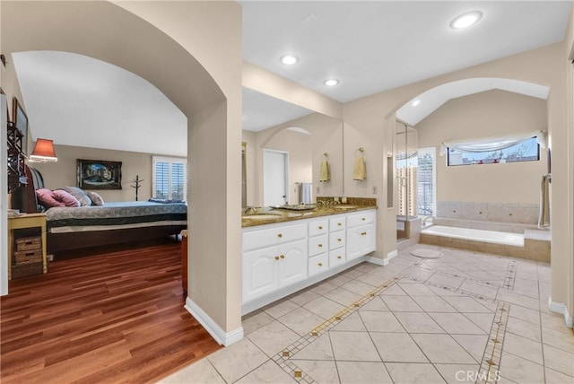 6153 Peridot Ave, Alta Loma, CA 91701 - ensuite bathroom featuring tile patterned flooring, a bath, double vanity, recessed lighting, and baseboards