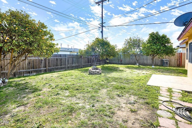 view of yard with a patio, an outdoor fire pit, and a fenced backyard