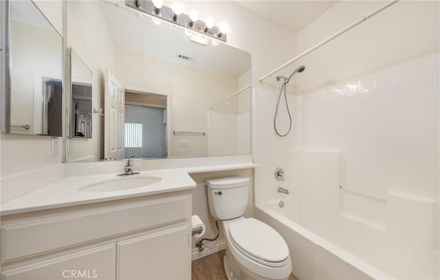 full bath featuring wood finished floors, bathtub / shower combination, vanity, and toilet