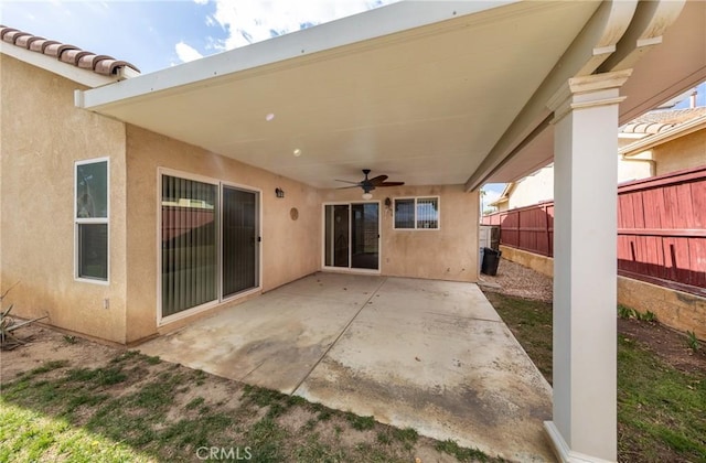 view of patio featuring fence and a ceiling fan