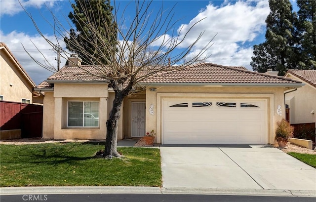 view of front of home with a garage, fence, a tiled roof, driveway, and stucco siding