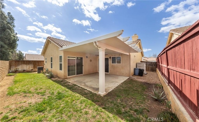 back of house with a patio, a fenced backyard, and stucco siding