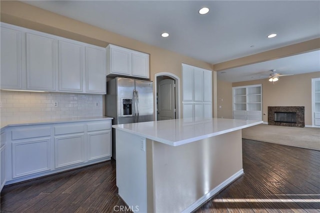 1230 Cantania Dr, Redlands, CA 92374 - kitchen with stainless steel fridge, dark wood finished floors, a fireplace, ceiling fan, and a center island