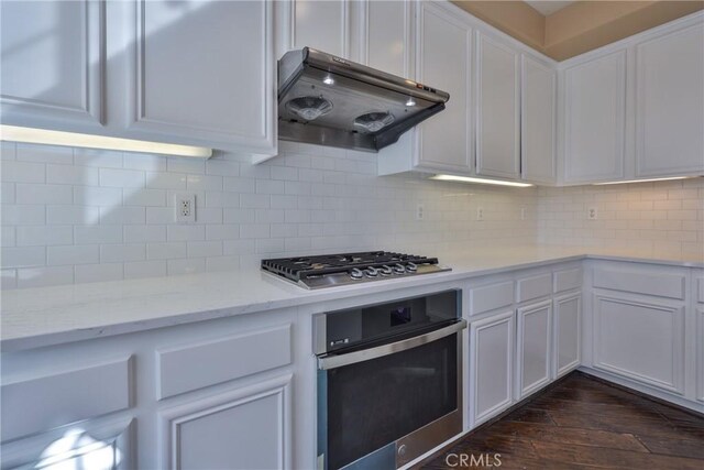 1230 Cantania Dr, Redlands, CA 92374 - kitchen with stainless steel appliances, extractor fan, white cabinetry, and backsplash