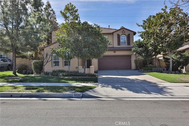 1230 Cantania Dr, Redlands, CA 92374 - view of front of home featuring concrete driveway, a garage, a tiled roof, stucco siding, and a front lawn