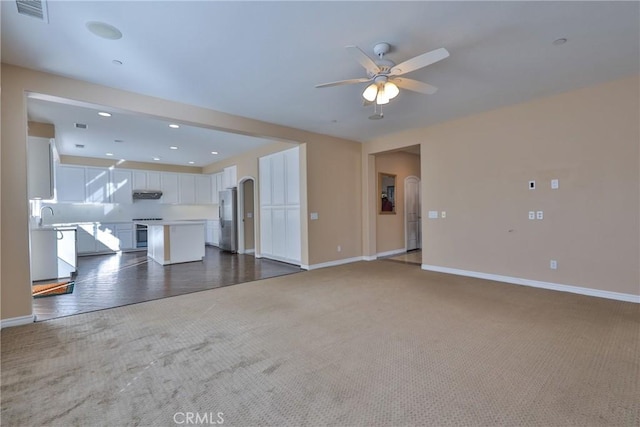 unfurnished living room featuring carpet floors, recessed lighting, visible vents, a ceiling fan, and baseboards