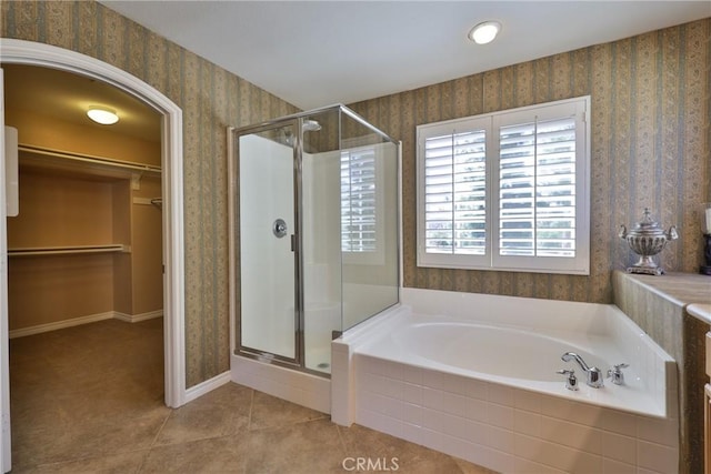 full bath featuring wallpapered walls, tile patterned flooring, a bath, and a stall shower