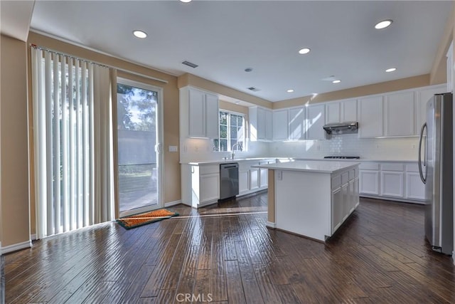 1230 Cantania Dr, Redlands, CA 92374 - kitchen featuring appliances with stainless steel finishes, dark wood-style flooring, backsplash, white cabinets, and recessed lighting