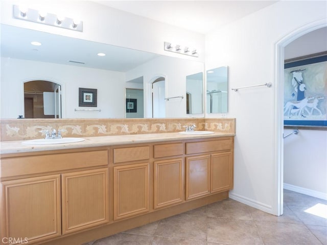 1230 Cantania Dr, Redlands, CA 92374 - full bathroom with double vanity, tasteful backsplash, tile patterned floors, and baseboards