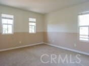 1230 Cantania Dr, Redlands, CA 92374 - unfurnished room featuring plenty of natural light, baseboards, and carpet flooring