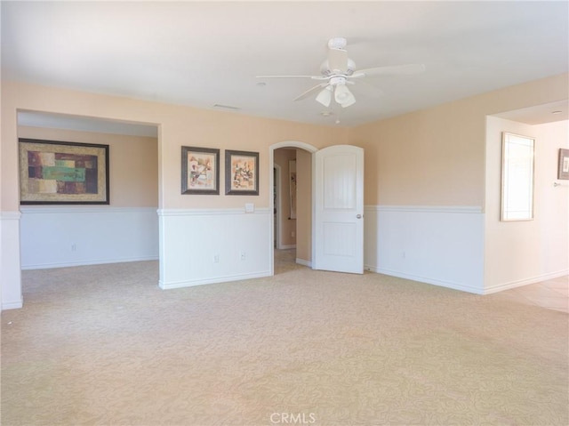 1230 Cantania Dr, Redlands, CA 92374 - empty room with carpet, arched walkways, a ceiling fan, and wainscoting