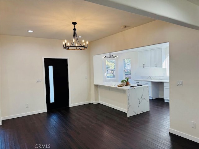 interior space featuring dark wood finished floors, recessed lighting, an inviting chandelier, and baseboards