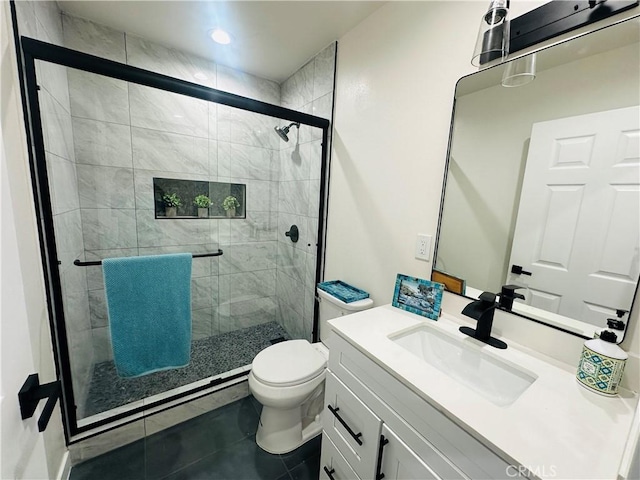 full bath with vanity, toilet, a shower stall, and tile patterned flooring