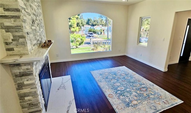 interior space featuring baseboards and wood finished floors