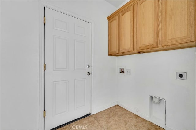 washroom with washer hookup, hookup for a gas dryer, cabinet space, hookup for an electric dryer, and baseboards