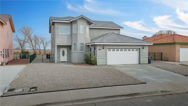 traditional-style home featuring driveway, a tile roof, an attached garage, a gate, and stucco siding