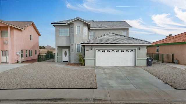 traditional-style home with driveway, a tiled roof, and stucco siding