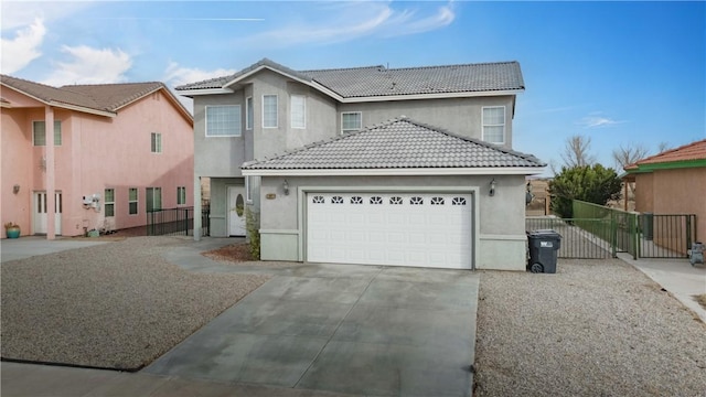 traditional home with a garage, a gate, driveway, and stucco siding