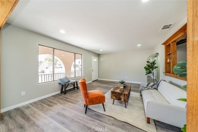 interior space featuring baseboards, visible vents, wood finished floors, and recessed lighting