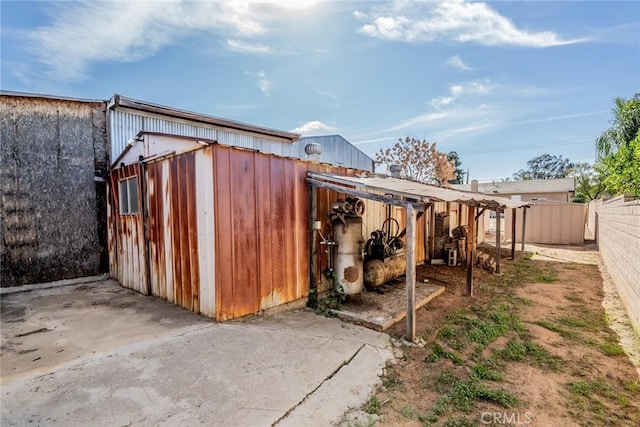 view of outbuilding with an outdoor structure and fence