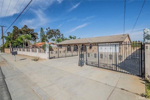 ranch-style house featuring a fenced front yard