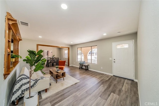 entryway featuring recessed lighting, visible vents, baseboards, and wood finished floors