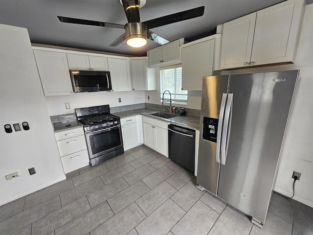 kitchen featuring appliances with stainless steel finishes, white cabinetry, and a sink