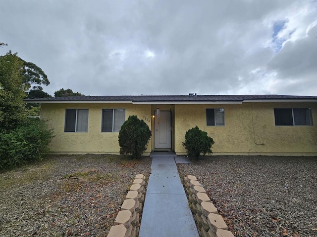 ranch-style home featuring stucco siding