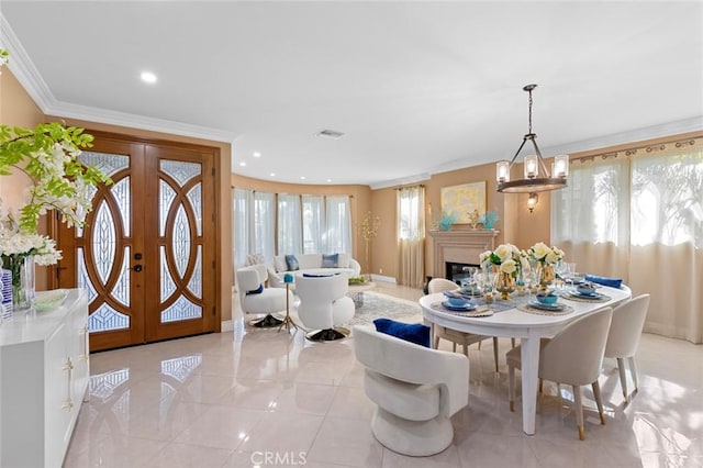 dining space featuring ornamental molding, french doors, light tile patterned flooring, and a glass covered fireplace