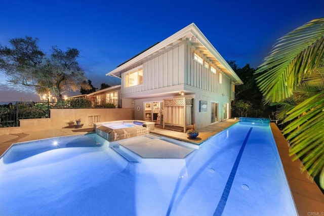 view of swimming pool featuring a pool with connected hot tub