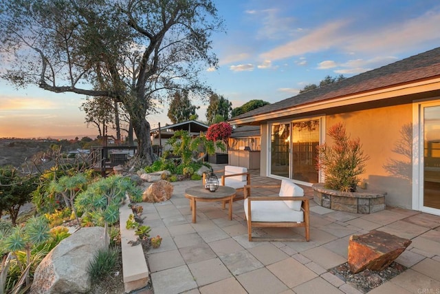 view of patio terrace at dusk