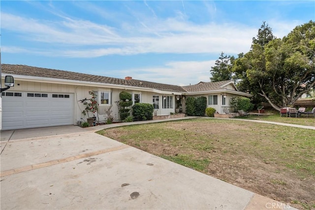 ranch-style home with an attached garage, board and batten siding, a front lawn, and concrete driveway