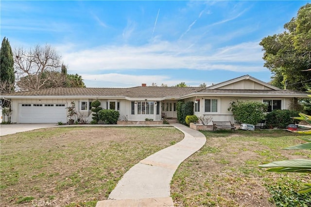 single story home with a garage, driveway, and a front lawn