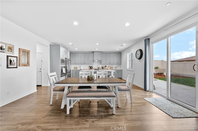 dining space featuring recessed lighting, baseboards, and wood finished floors