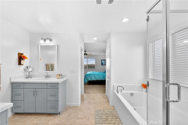 bathroom with a stall shower, a garden tub, vanity, and connected bathroom