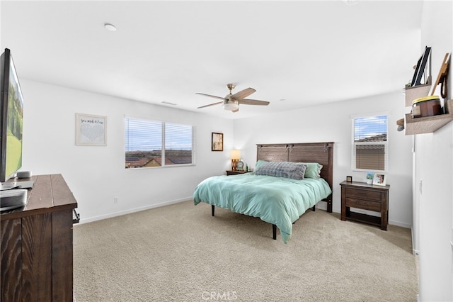 bedroom with multiple windows, baseboards, and light colored carpet