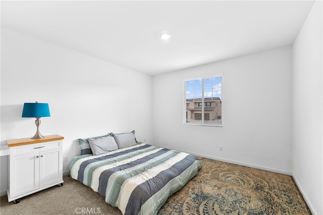 bedroom featuring light colored carpet and baseboards