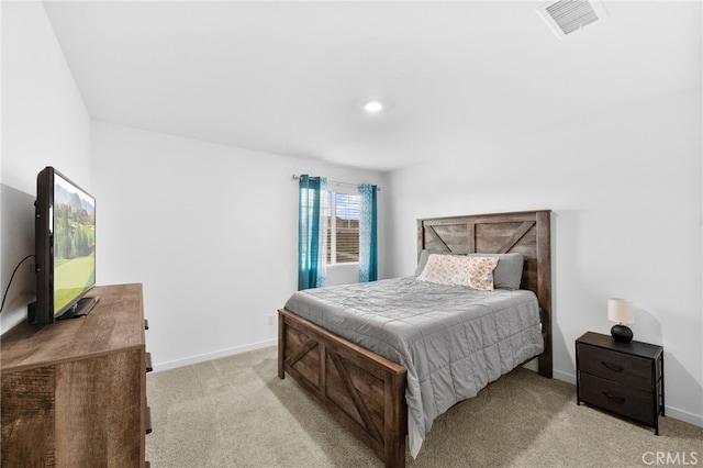 bedroom with light colored carpet, visible vents, and baseboards