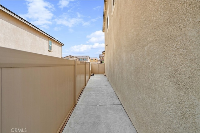 view of home's exterior with fence and stucco siding