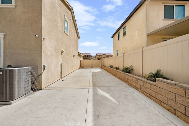 view of home's exterior featuring a patio area, stucco siding, fence, and central AC unit