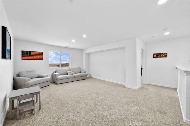 carpeted living room featuring baseboards and recessed lighting